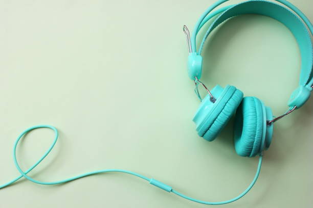 istock Headphones turquoise on a light green background. Copy Space. 1159045558