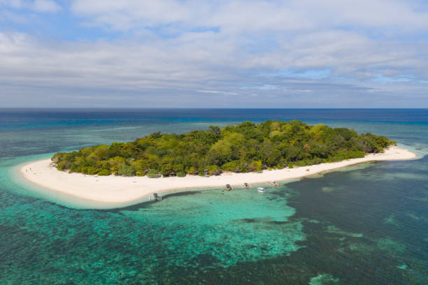 istock A small island surrounded by azure water and coral reefs, a top view 1159046481