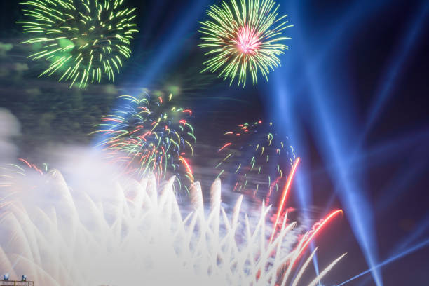 istock Colored firework background with free space for text. Colorful fireworks at night light up the sky with dazzling display. 1159047561
