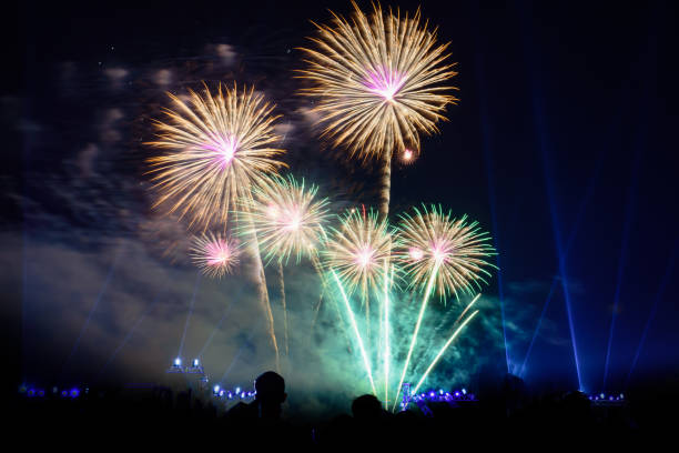 istock Colored firework background with free space for text. Colorful fireworks at night light up the sky with dazzling display. 1159047596