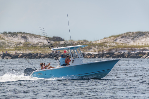 Panama City, Florida, USA 06/28/2019. Boat traveling through the pass, jetties, St. Andrews State Park for a day of fishing in the gulf of mexico