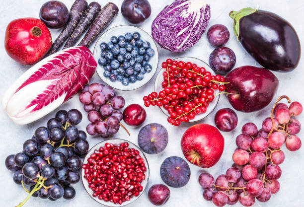 Purple and red color fruits and vegetables top view. Purple and red color fruits and vegetables ingredients top view on rustic white background. plum red white purple stock pictures, royalty-free photos & images