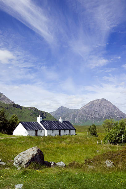 Blackrock cottage with cloud formations over mountains Blackrock cottage with cloud formations over mountains. buachaille etive mor photos stock pictures, royalty-free photos & images