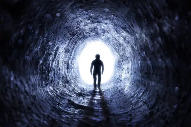 Man Walking To The Light At The End Of The Tunnel - Hope After Life