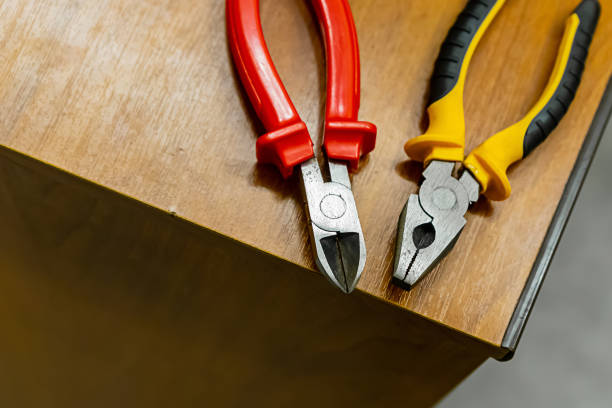 istock two nippers red black yellow plastic knobs work with electricity electrical appliances on edge table 1159052518