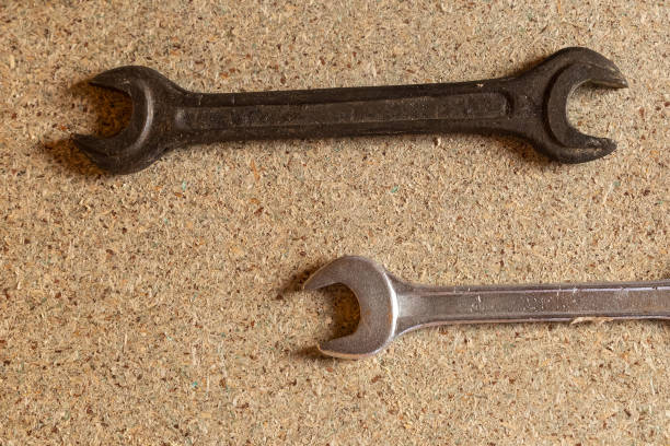 istock two wrenches lie on a wooden surface, repair the house. pair of hand tools parallel horizontal 1159053131