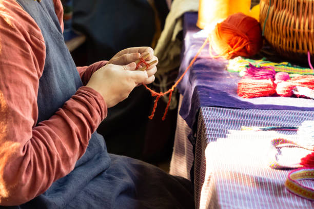 istock hands knitting with needles red thread traditional production. Rustic design manual production 1159053143