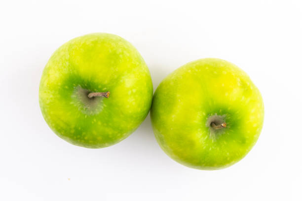 istock ripe juicy green apples focus top view on white background fruit set 1159053812