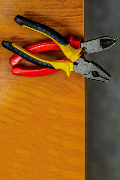 istock set pliers iron rubber handle pair black yellow red lower frame copy space wooden table 1159053863