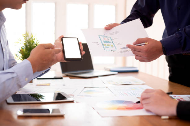 istock Mock up. Creative designers planning work together on applications on mobile phone and websites. 1159056033
