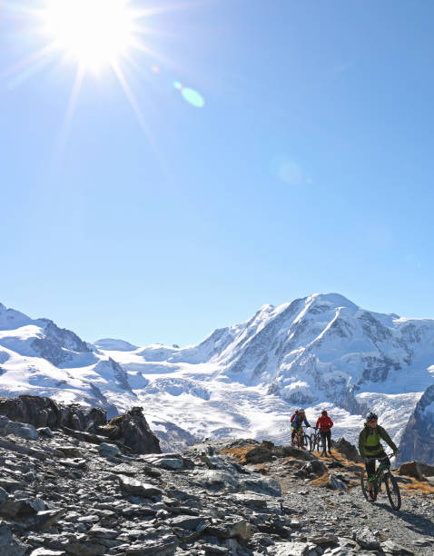 istock Mountain bikers ride along a rocky ridge on the Gornergrat above Zermatt 1159057821