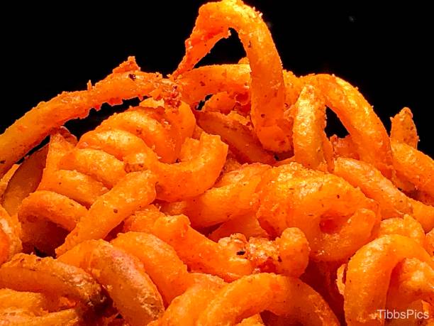 Curly Fries Close-up of crispy curly french fries. So mouthwatering. curly fries stock pictures, royalty-free photos & images