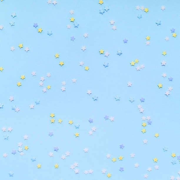 istock Little star-shaped confetti on a blue background. 1159058792