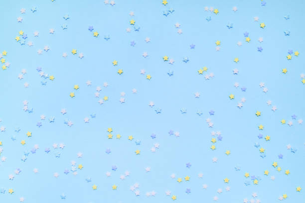 istock Little star-shaped confetti on a blue background. 1159058793