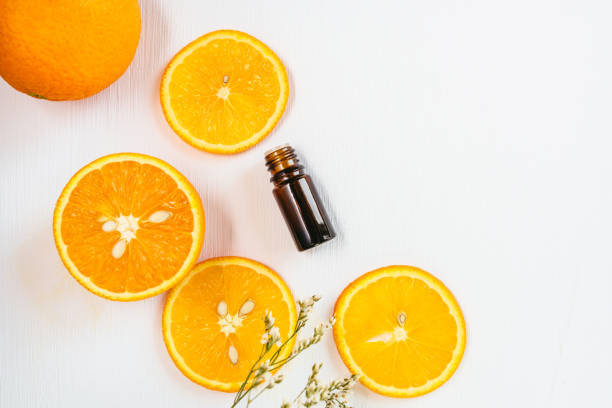 istock Bottle of orange essential oil on white background 1159060683