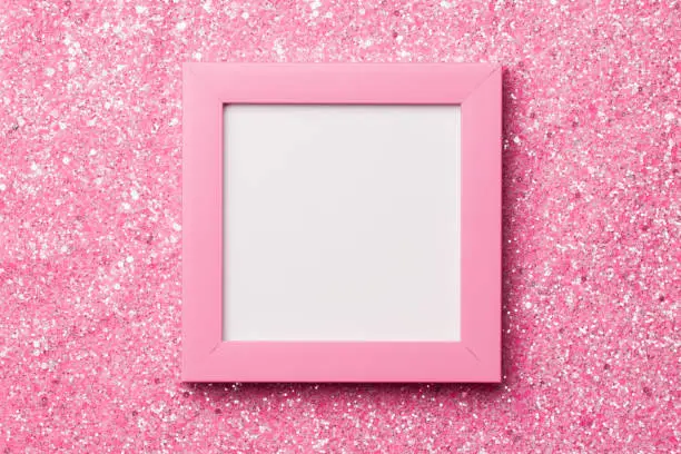 Photo of Pink frame on a shiny glitter background.