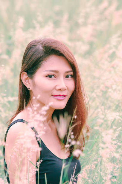 istock Woman sitting in a meadow 1159063399