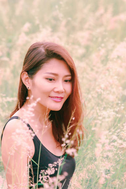 istock Woman sitting in a meadow 1159063438