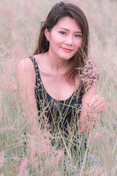 istock Woman sitting in a meadow 1159063440