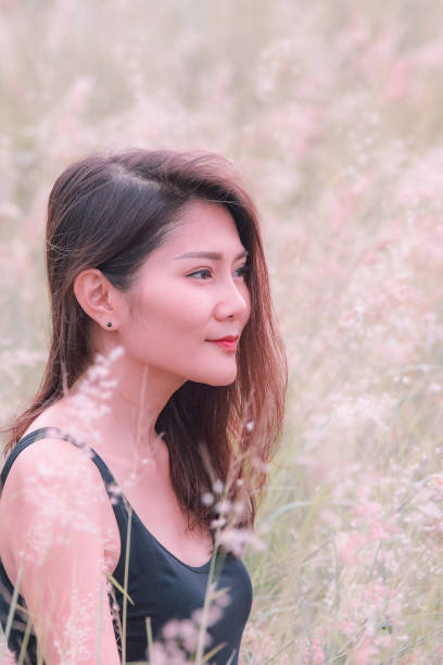 istock Woman sitting in a meadow 1159063477