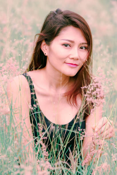 istock Woman sitting in a meadow 1159063481