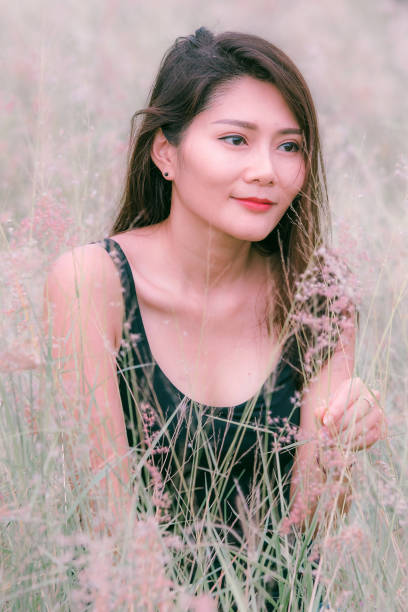 istock Woman sitting in a meadow 1159063488