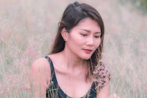 istock Woman sitting in a meadow 1159063494