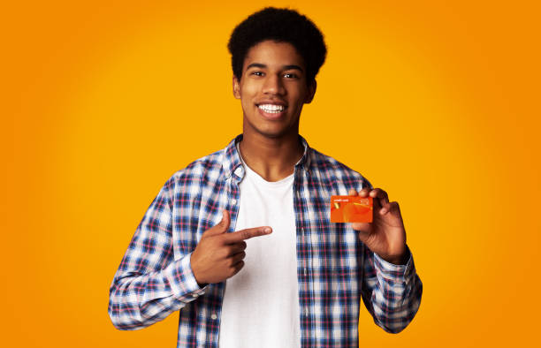 istock Happy Guy Holding Credit Card and Point on It 1159063521
