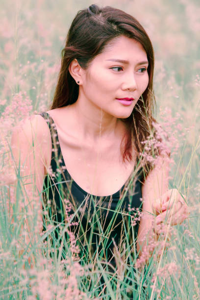 istock Woman sitting in a meadow 1159063526