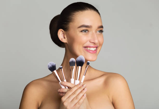 istock Excited Woman Holding Set of Makeup Brushes 1159063577