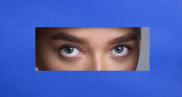 istock Beautiful Female Eyes in Blue Paper Frame 1159063625