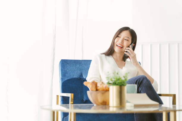 istock Young Asian woman using phone talking happy and smile. 1159065650
