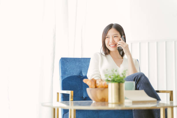 istock Young Asian woman using phone talking happy and smile. 1159065652