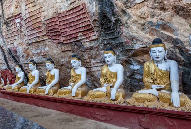 istock Old temple with buddha statues in Kaw Goon cave. 1159066053