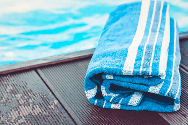 istock blue towel near swimming pool, tropical background 1159068796