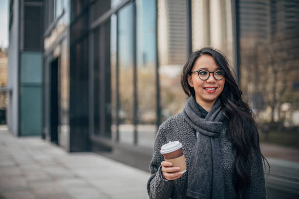 istock Pretty woman holding takeout coffee 1159069750