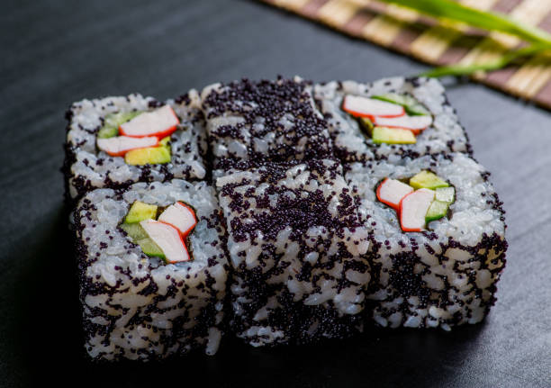 istock Japanese sushi and rolls on a black background 1159071238