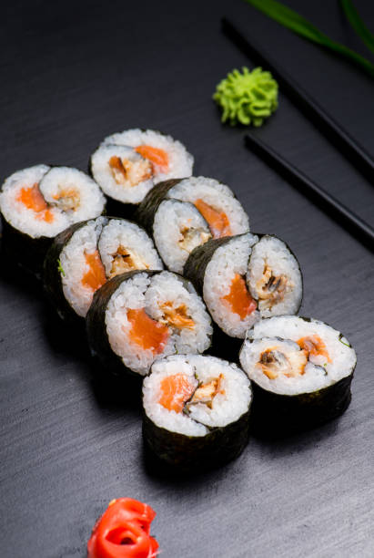 istock Japanese sushi and rolls on a black background 1159071756