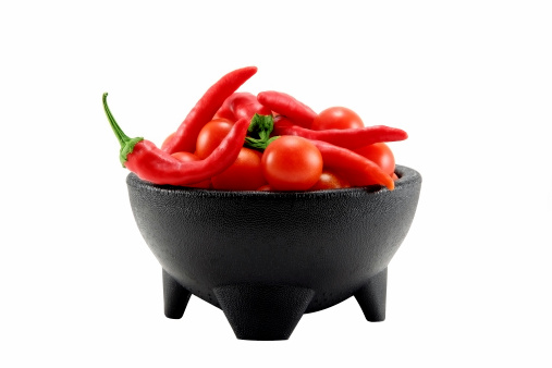 Fresh Salsa in a black bowl isolated on white