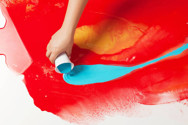 istock How to make acrylic painting. Work in progress. Female hand holding a plastic cup with blue paint. 1159075672