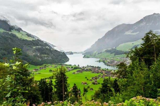 Beautiful View on cloudy Lungerersee (Lungernersee, Lungernsee, Lungern lake), and alps in Switzerland. Viewing point Schoenbuehel.