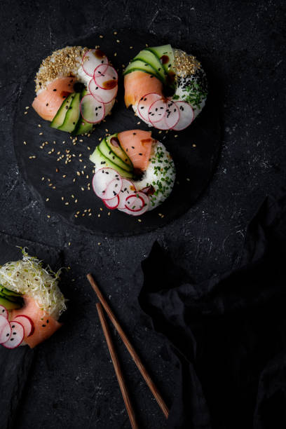 istock Sushi donuts on dark background. Top view. 1159077433