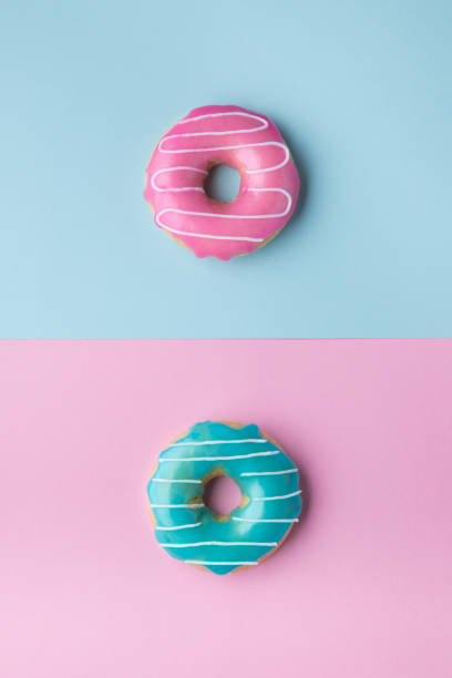 istock Blue and pink donuts on pink and blue background. 1159077437