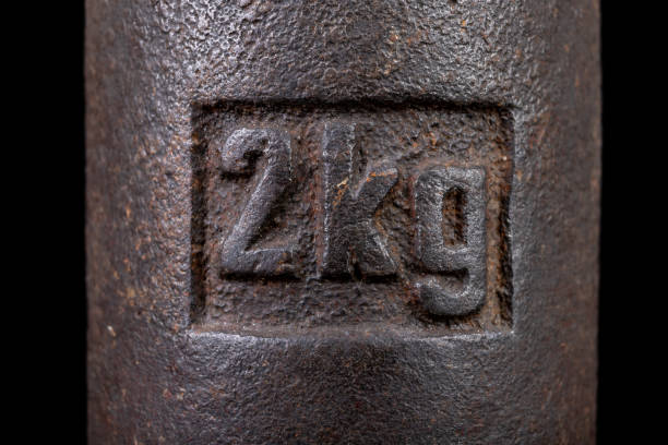 istock Old kilo weights on books. Old books and weighing machines. Dark background. 1159081925