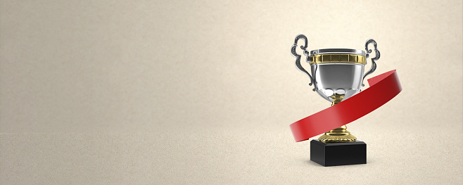 3D gold tophy award standing on craft white background with 3D red blank banner, you can write your own message on it.  Panoramic aspect ratio and large copy space.