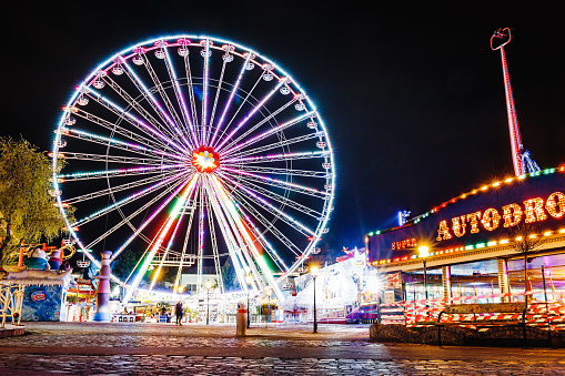 Vienna, Austria, 24 March 2017: Lighting Ferris wheel at night in famous Prater theme amusement Park, Vienna