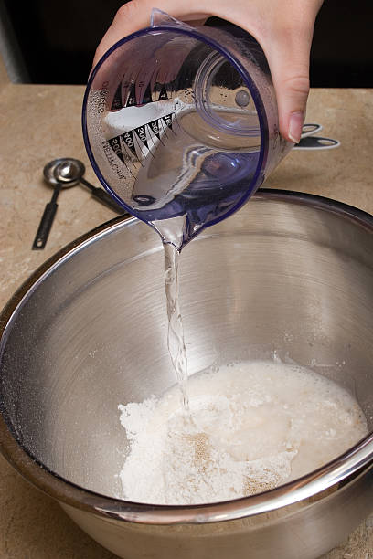 pouring water baking beginnings, pouring measured water into baking dish tsp stock pictures, royalty-free photos & images
