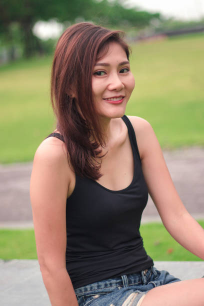 istock woman sat in the park and smiled 1159086360