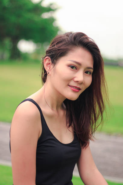 istock woman sat in the park and smiled 1159086390