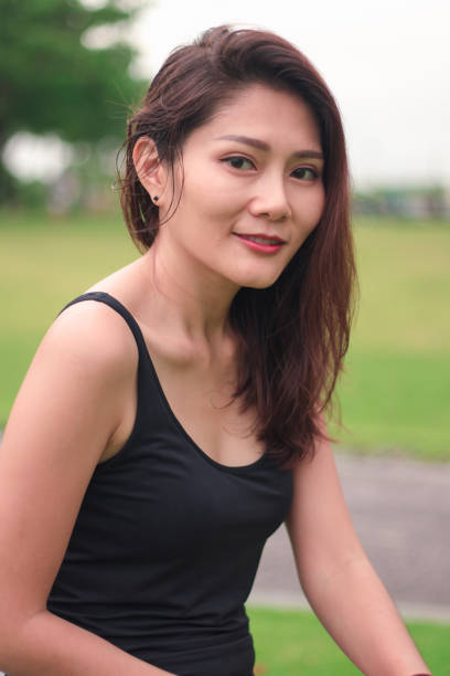 istock woman sat in the park and smiled 1159086408